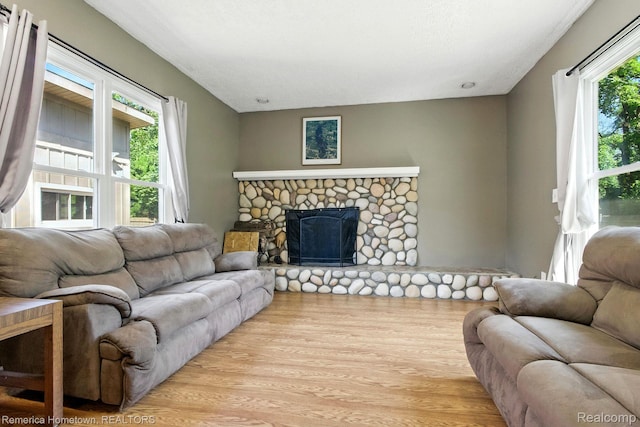 42424 Bradner Ct, Plymouth, MI 48170 - living area with wood finished floors and a stone fireplace