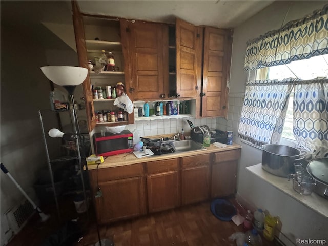 11343 Belleterre St, Detroit, MI 48204 - kitchen with brown cabinetry, light countertops, tasteful backsplash, open shelves, and dark wood-style floors