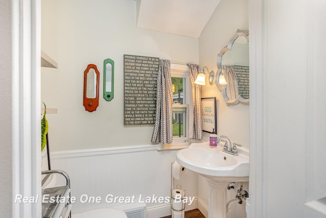 4185 Shattuck Rd, Saginaw, MI 48603 - half bathroom featuring wainscoting and toilet