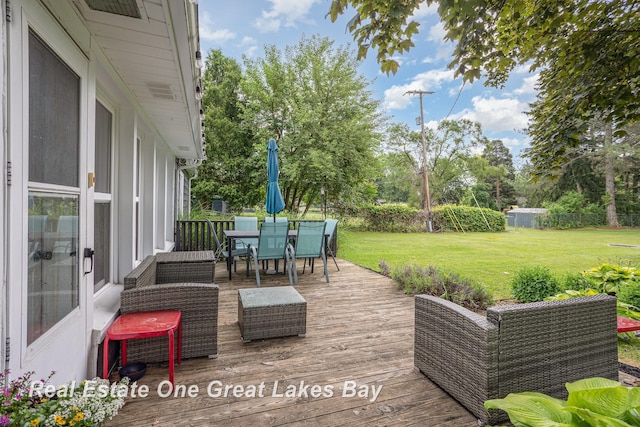 4185 Shattuck Rd, Saginaw, MI 48603 - deck with a lawn, outdoor dining area, and view of scattered trees