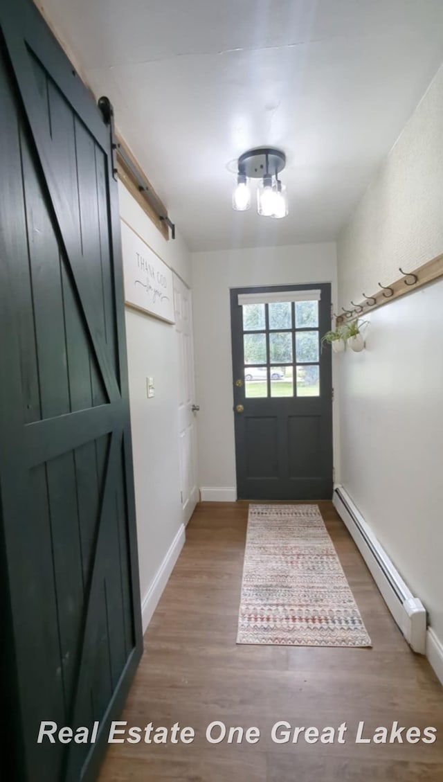 4185 Shattuck Rd, Saginaw, MI 48603 - doorway featuring a baseboard radiator, a barn door, and wood finished floors