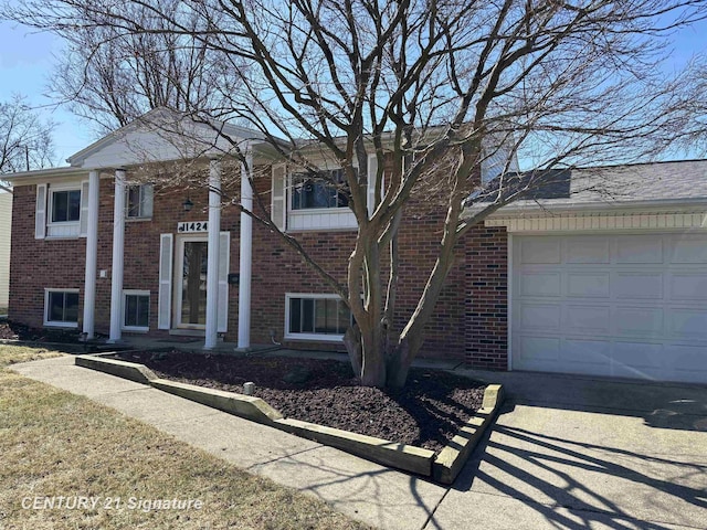 11424 Hazel Ave, Grand Blanc, MI 48439 - view of front facade featuring a garage and brick siding