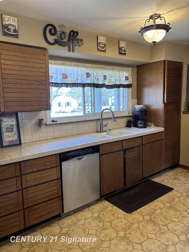 11424 Hazel Ave, Grand Blanc, MI 48439 - kitchen with dishwasher, decorative backsplash, brown cabinetry, and tile countertops