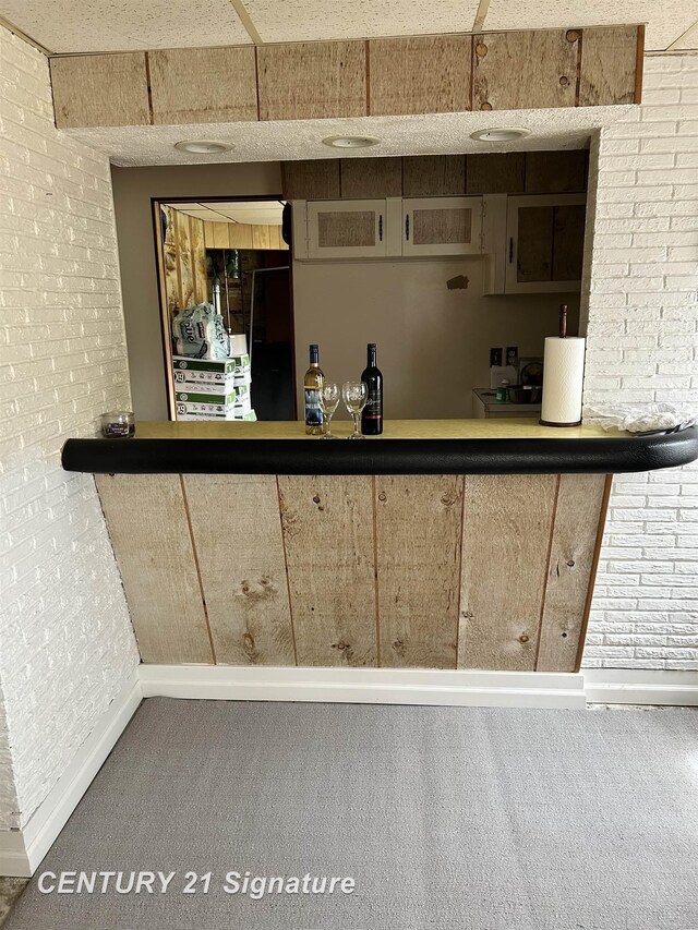 11424 Hazel Ave, Grand Blanc, MI 48439 - indoor dry bar with carpet floors and brick wall
