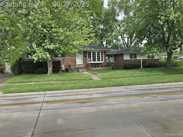 3609 River Dr, Lincoln Park, MI 48146 - view of front of house featuring brick siding and a front lawn