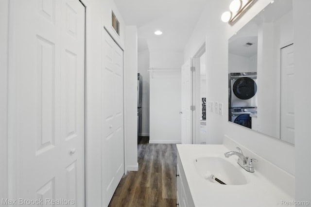 165 W Colgate Ave, Pontiac, MI 48340 - bathroom with estacked washer and dryer, vanity, wood finished floors, recessed lighting, and a closet