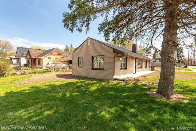 165 W Colgate Ave, Pontiac, MI 48340 - view of home's exterior with a chimney and a lawn