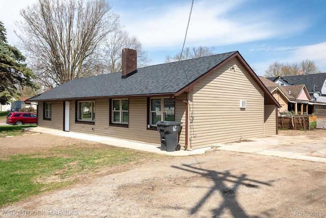 165 W Colgate Ave, Pontiac, MI 48340 - rear view of property featuring roof with shingles and a chimney