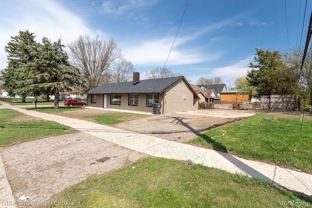 165 W Colgate Ave, Pontiac, MI 48340 - ranch-style house with driveway, a chimney, and a front yard