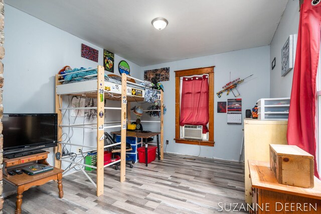 409 W Bridge St, Lyons, MI 48851 - bedroom with cooling unit and wood finished floors