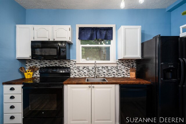 409 W Bridge St, Lyons, MI 48851 - kitchen featuring butcher block counters, black appliances, tasteful backsplash, white cabinetry, and a textured ceiling