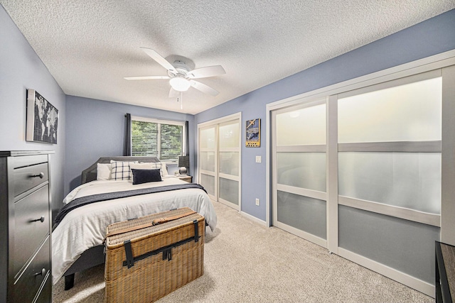 117 High View Ct, Brooklyn, MI 49230 - carpeted bedroom with a textured ceiling, ceiling fan, and multiple closets