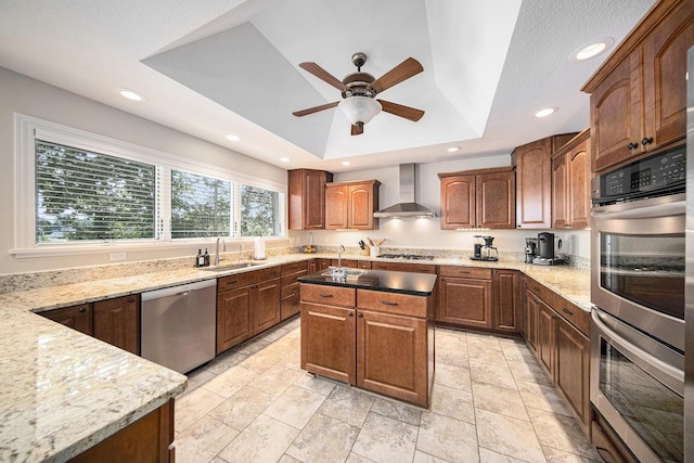 117 High View Ct, Brooklyn, MI 49230 - kitchen featuring appliances with stainless steel finishes, wall chimney exhaust hood, a raised ceiling, a ceiling fan, and light stone counters