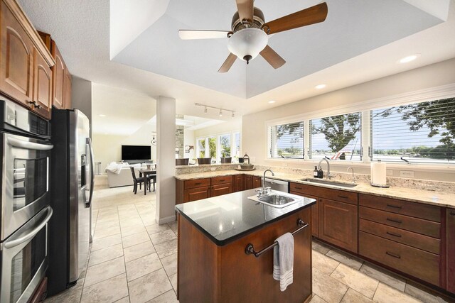 117 High View Ct, Brooklyn, MI 49230 - kitchen featuring stainless steel appliances, an island with sink, light stone countertops, a ceiling fan, and recessed lighting