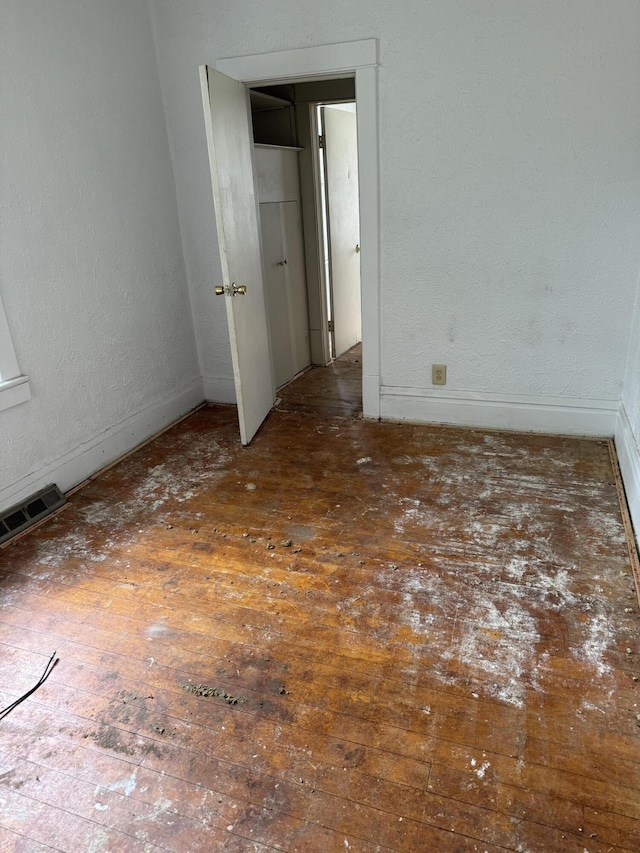 774 Amity Ave, Muskegon, MI 49442 - unfurnished bedroom with wood-type flooring and baseboards