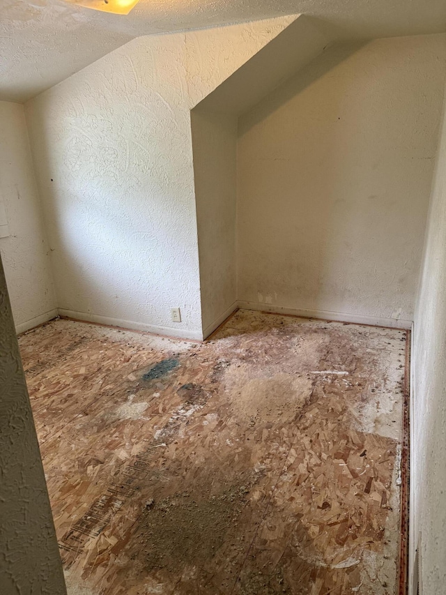 774 Amity Ave, Muskegon, MI 49442 - unfurnished room featuring vaulted ceiling and a textured ceiling