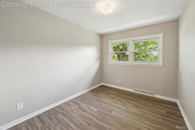 15501 Turner, Lansing, MI 48906 - spare room with wood finished floors and a baseboard radiator