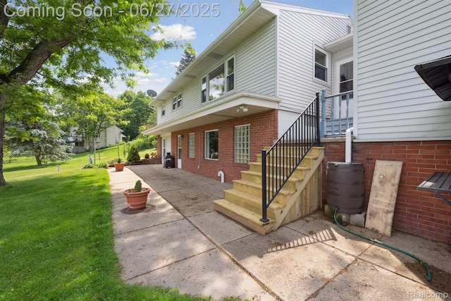 15501 Turner, Lansing, MI 48906 - view of side of property featuring a yard, brick siding, and a patio