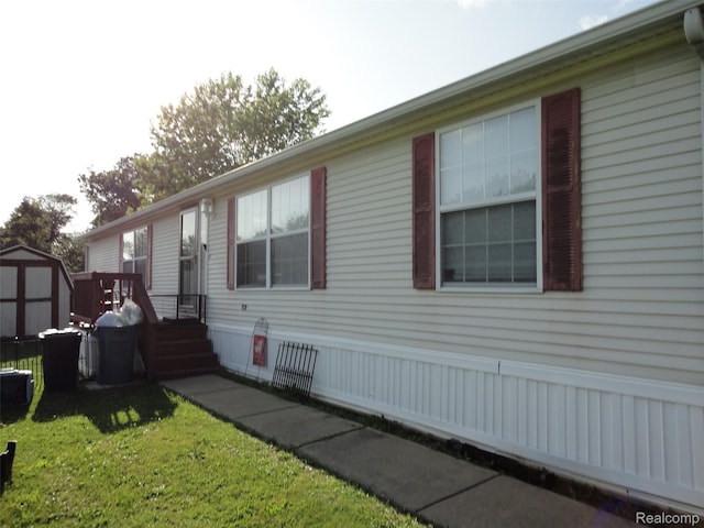 453 Glencoe Dr, Temperance, MI 48182 - view of home's exterior featuring a shed and a lawn