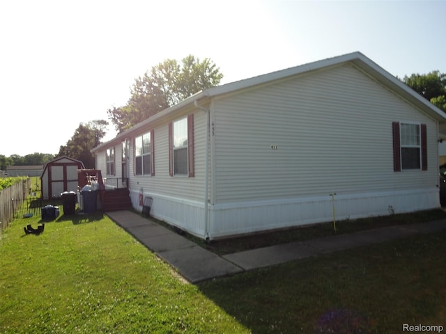 453 Glencoe Dr, Temperance, MI 48182 - view of side of property with a storage unit and a yard