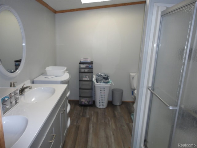 453 Glencoe Dr, Temperance, MI 48182 - bathroom featuring wood finished floors, double vanity, a shower stall, and ornamental molding