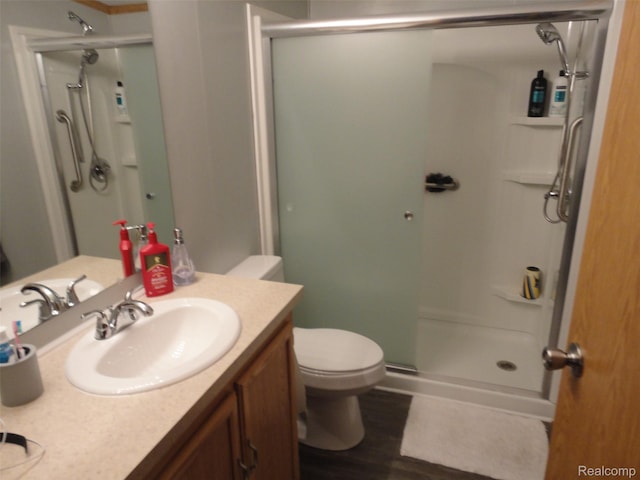 453 Glencoe Dr, Temperance, MI 48182 - full bathroom with a shower stall, vanity, and wood finished floors