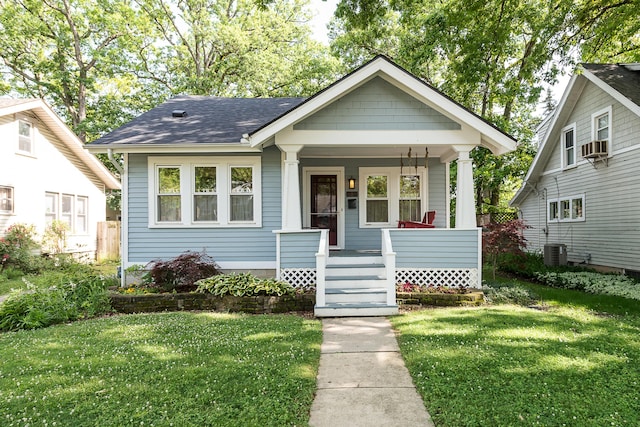 809 Pauline Blvd, Ann Arbor, MI 48103 - bungalow-style home featuring a porch, a front lawn, roof with shingles, and cooling unit
