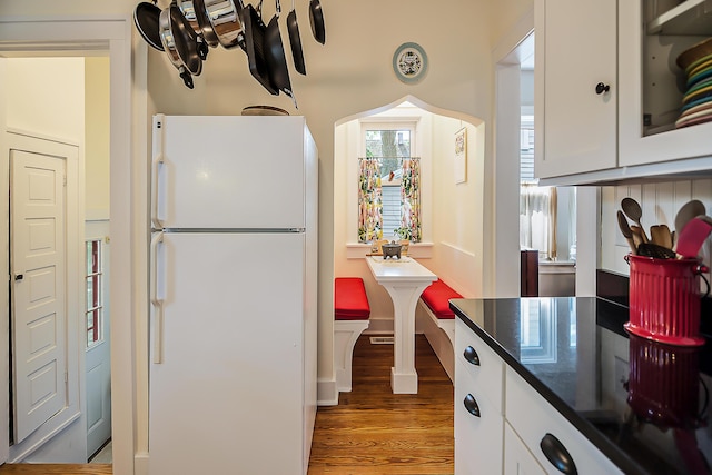 809 Pauline Blvd, Ann Arbor, MI 48103 - kitchen featuring freestanding refrigerator, light wood-style flooring, white cabinetry, and dark countertops