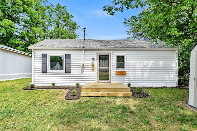 521 E Morrell St, Otsego, MI 49078 - single story home with a front lawn, a shingled roof, and a deck