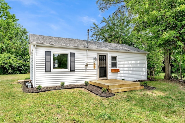 521 E Morrell St, Otsego, MI 49078 - view of front of home featuring a front lawn, a shingled roof, and a wooden deck