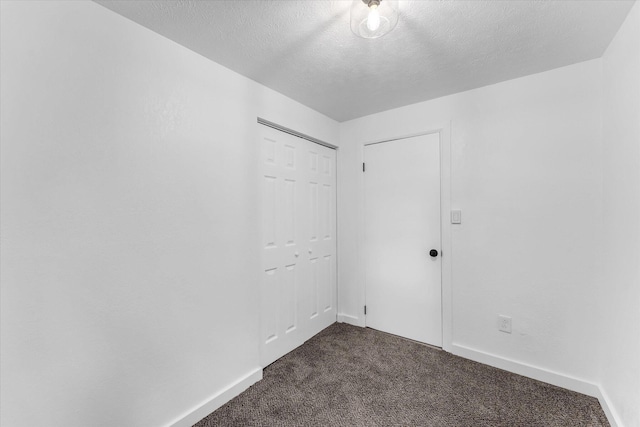 521 E Morrell St, Otsego, MI 49078 - spare room featuring dark colored carpet and a textured ceiling
