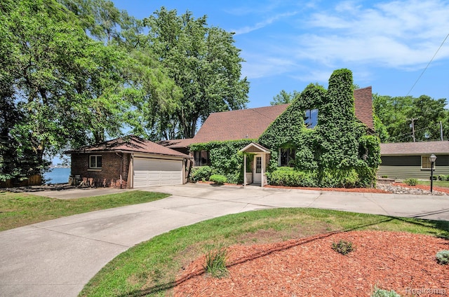 2058 S Long Lake Rd, Fenton, MI 48430 - view of front of home with driveway, an attached garage, and brick siding