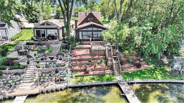 2058 S Long Lake Rd, Fenton, MI 48430 - back of house featuring a water view, a patio area, an outdoor fire pit, a sunroom, and stairway