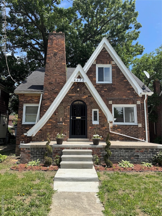 4670 Devonshire Rd, Detroit, MI 48224 - tudor-style house with a chimney and brick siding