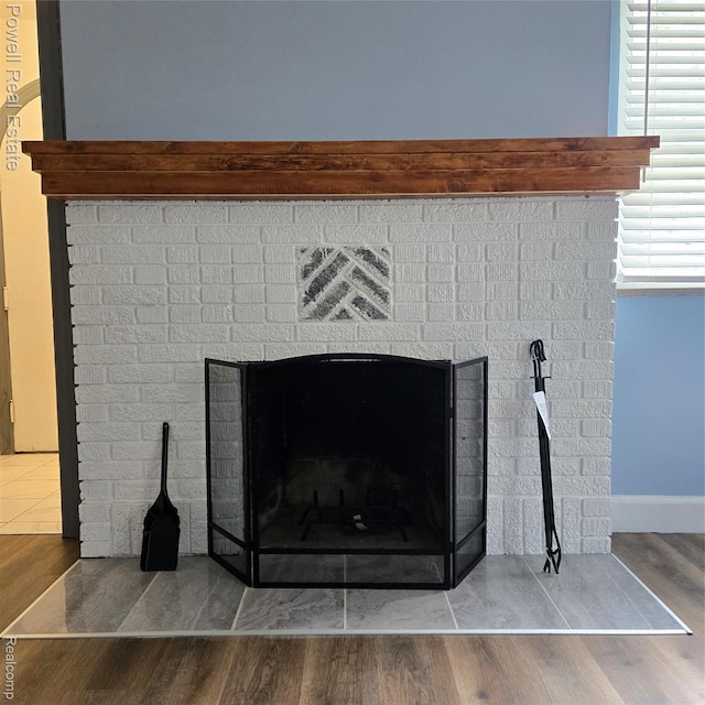 4670 Devonshire Rd, Detroit, MI 48224 - detailed view of a brick fireplace and wood finished floors