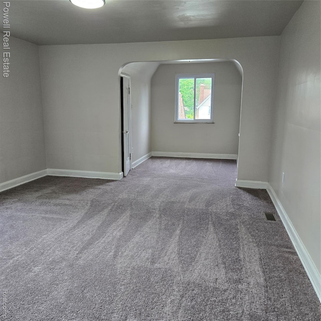 4670 Devonshire Rd, Detroit, MI 48224 - empty room featuring carpet and arched walkways