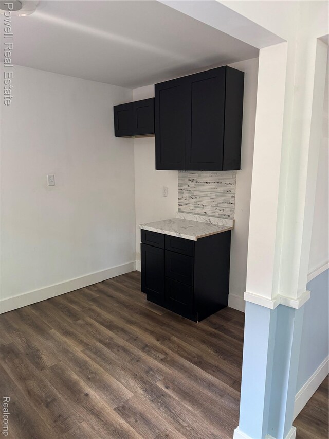 4670 Devonshire Rd, Detroit, MI 48224 - bar with dark wood-type flooring and tasteful backsplash