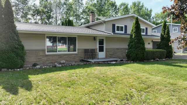11427 Colonial Woods Dr, Clio, MI 48420 - tri-level home featuring brick siding, a chimney, a front yard, roof with shingles, and a porch