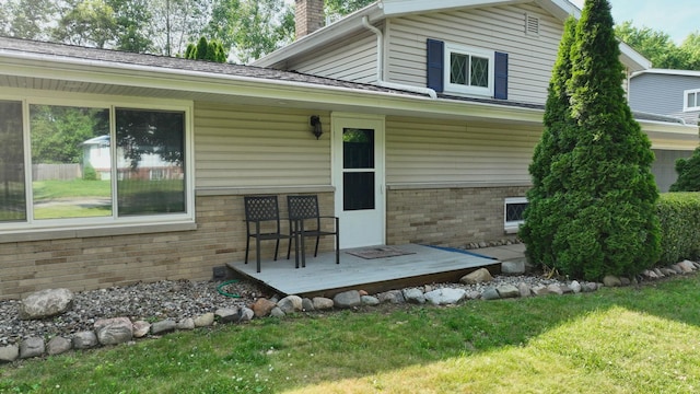 11427 Colonial Woods Dr, Clio, MI 48420 - rear view of house with brick siding, a chimney, and a lawn