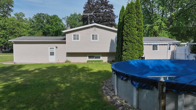 11427 Colonial Woods Dr, Clio, MI 48420 - back of property with a lawn and a covered pool