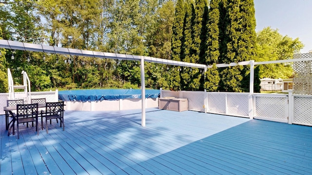 11427 Colonial Woods Dr, Clio, MI 48420 - wooden deck featuring a covered pool and outdoor dining space