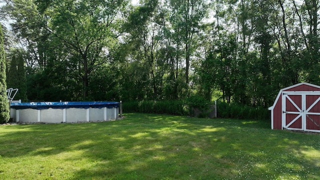 11427 Colonial Woods Dr, Clio, MI 48420 - view of grassy yard with a shed and a covered pool