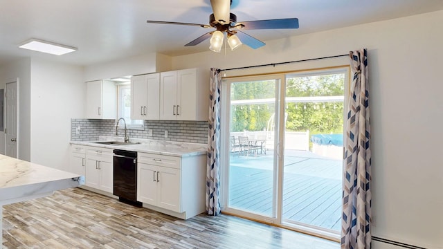 11427 Colonial Woods Dr, Clio, MI 48420 - kitchen with dishwasher, a baseboard radiator, backsplash, a ceiling fan, and white cabinetry