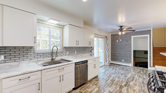 11427 Colonial Woods Dr, Clio, MI 48420 - kitchen with dishwasher, stove, a baseboard radiator, decorative backsplash, and ceiling fan