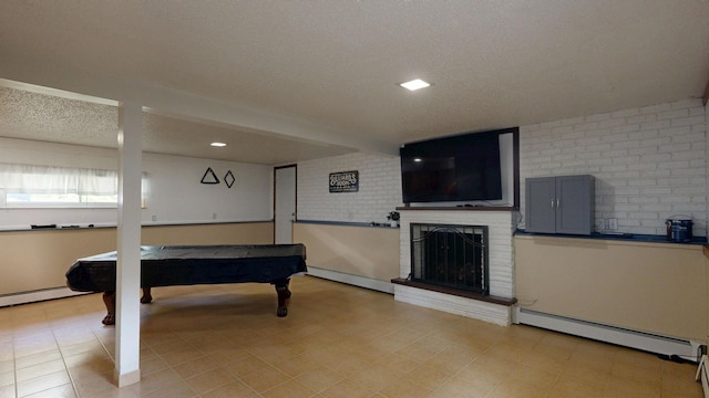 11427 Colonial Woods Dr, Clio, MI 48420 - rec room featuring baseboard heating, billiards, a brick fireplace, a textured ceiling, and recessed lighting