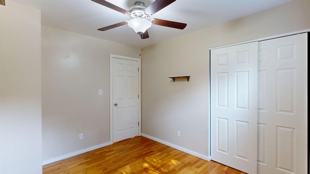 11427 Colonial Woods Dr, Clio, MI 48420 - unfurnished bedroom with light wood finished floors, a ceiling fan, and a closet