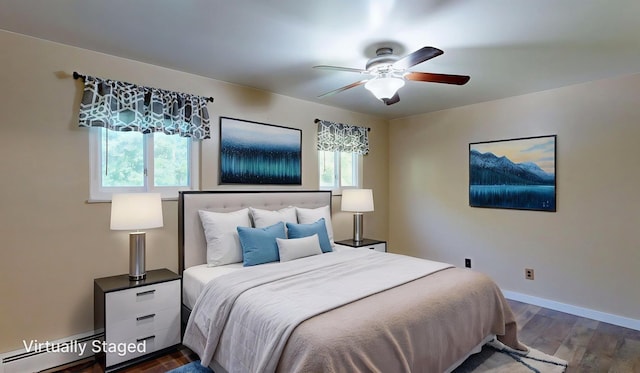 11427 Colonial Woods Dr, Clio, MI 48420 - bedroom featuring baseboard heating, dark wood-type flooring, and a ceiling fan