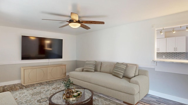 11427 Colonial Woods Dr, Clio, MI 48420 - living area with wood finished floors, ceiling fan, and track lighting