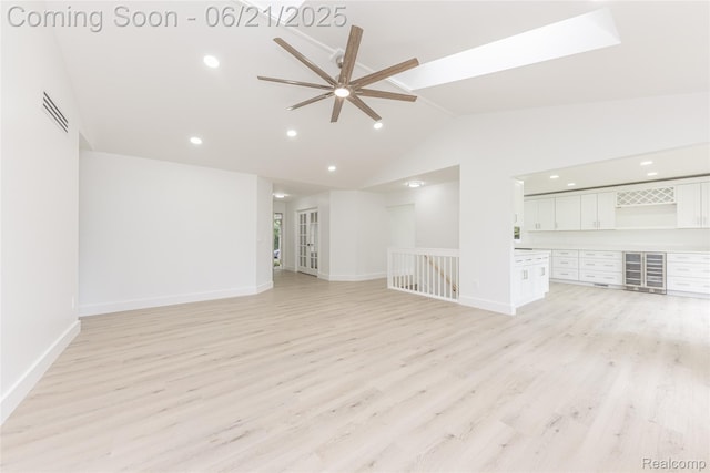 3145 Point Of The Woods Dr, West Bloomfield, MI 48324 - empty room featuring wine cooler, a ceiling fan, light wood-style floors, recessed lighting, and high vaulted ceiling