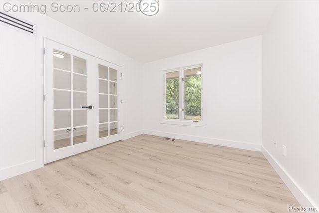 3145 Point Of The Woods Dr, West Bloomfield, MI 48324 - unfurnished room with light wood finished floors and french doors